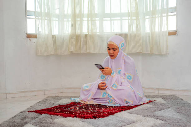 istock Muslim family using mobile at home during ramadhan 1216725474