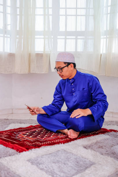 istock Muslim family using mobile at home during ramadhan 1216725477