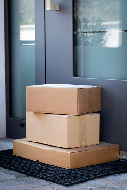 Packages left at front door for contactless delivery stock photo