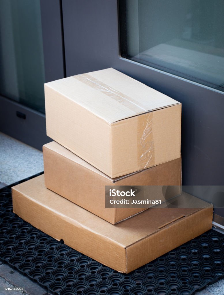 Packages left at front door for contactless delivery Packages left at front door for contactless delivery of online bought items Front Door Stock Photo