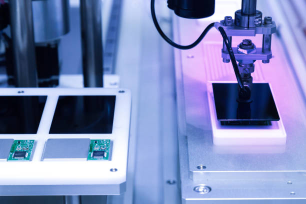 istock automatic robot arm with vacuum sucker working in the production line and assembling smartphone screens in the new innovative and high technology smartphone factory. 