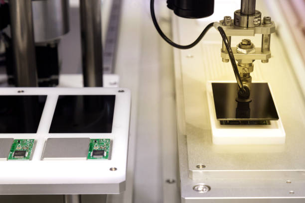 istock automatic robot arm with vacuum sucker working in the production line and assembling smartphone screens in the new innovative and high technology smartphone factory. 