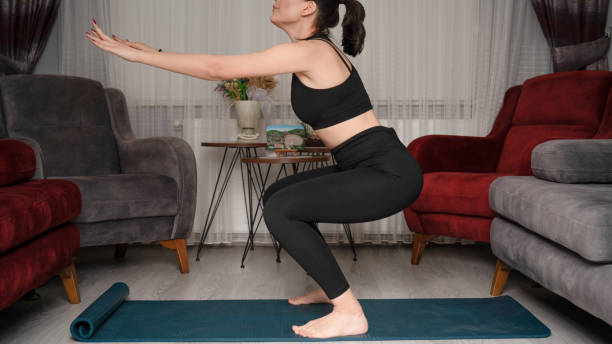 istock Young woman does exercises from home during quarantine time 1216735682