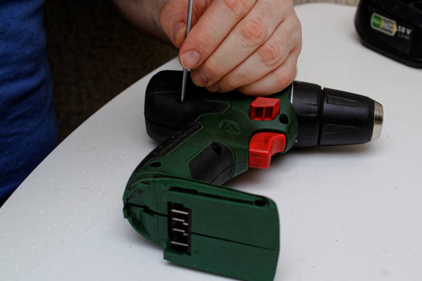 istock Engineer begins repairing a broken screwdriver. close the case of the screwdriver 1216736634