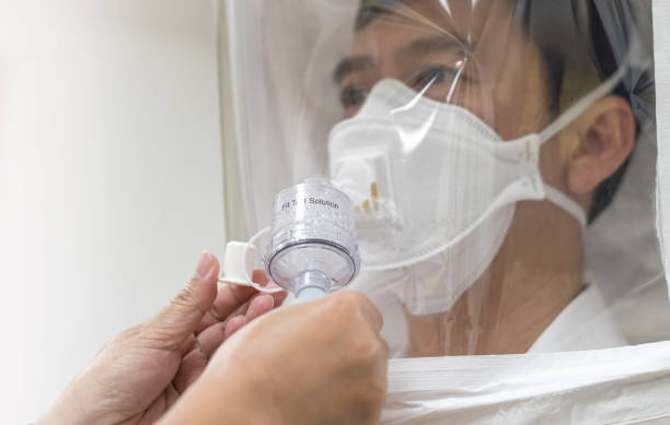 respirator fit test prepared for covid-19. asia man testing repiratory system with n-95 surgical mask to checks properly fits face to wears. - fittest imagens e fotografias de stock