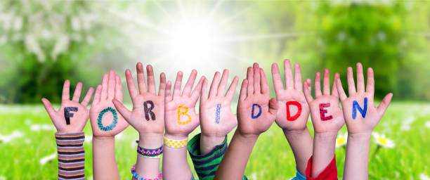 istock Children Hands Building Word Forbidden, Grass Meadow 1216737947