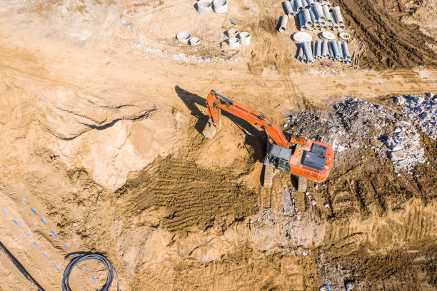 istock heavy excavator working at ground in construction site. aerial view 1216738808