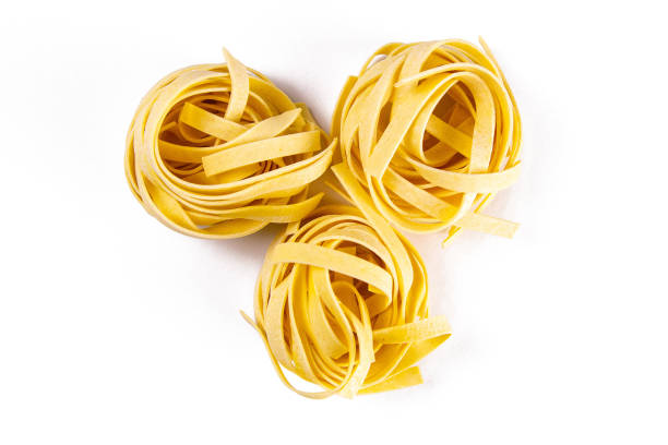 istock Row dry nest pasta on white bacground. Top views 1216740472