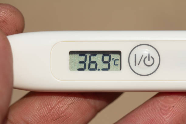 istock Electronic thermometer in a hand Stop Coronavirus. Coronavirus (2019-nCoV). Temperature 36.9 Normal without fever. 1216742023