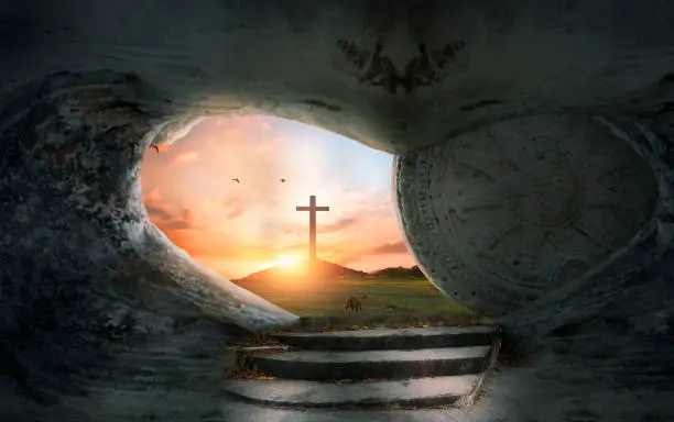 Good Friday concept: Tomb empty with cross on sunset background