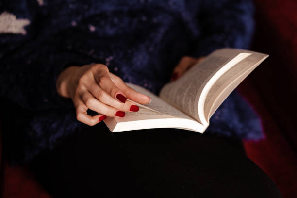 istock Young woman is reading book from home during quarantine time 1216743285