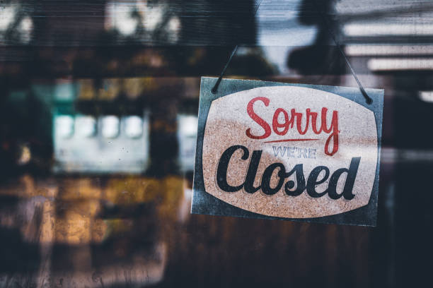 Sorry we're closed . grunge image hanging on a cafe window, Coronavirus COVID-19 outbreak lockdown. stock photo