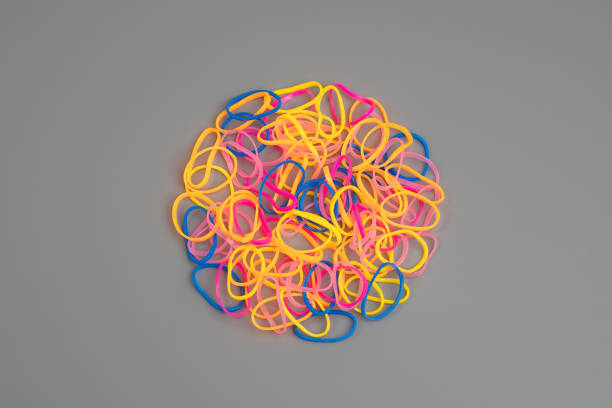 istock Close-Up Of Multi Colored Rubber Bands Over Gray background 1216746865