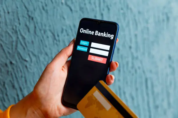 Photo of Online banking concept. Woman holding phone and credit card isolated.