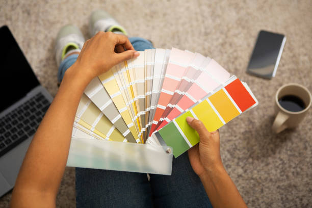 istock Girl chooses paint for interior from color swatch 1216749530