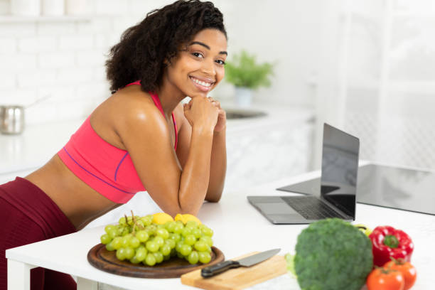 istock Black girl using laptop searching recipes looking at camera 1216749838