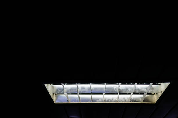 istock The fluorescent lamp on the ceiling. The background is black. 1216750125