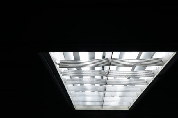 istock The fluorescent lamp on the ceiling. The background is black. 1216750154