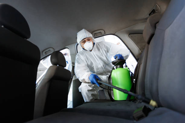 Man in protective suit disinfecting with chemicals his car Man in protective suit disinfecting with chemicals his car from coronavirus, copy space biohazard cleanup stock pictures, royalty-free photos & images