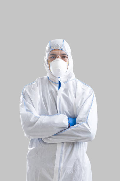 istock Man in protective suit and gloves with crossed arms 1216751651