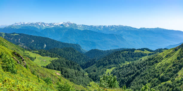 istock Panoramic view over the Green Valley, surrounded by high mountains with snow on a clear summer day. 1216753011