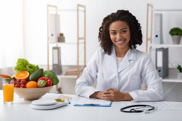 istock Attractive female nutritionist posing at her modern office 1216754481