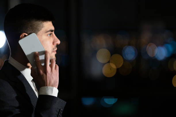 istock Serious Businessman Talking On Mobile Phone Standing In Office, Side-View 1216755123