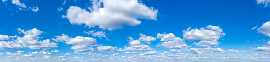 Cumulus clouds appear in a blue sky over Marshall Lake in the Coconino National Forest near Flagstaff, Arizona, USA.