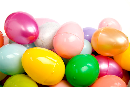 Easter chocolate eggs and candies on white wooden table