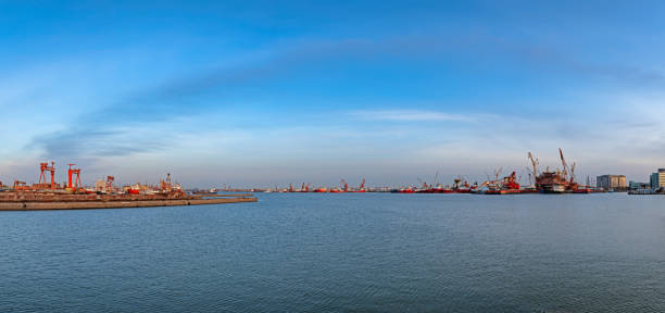 istock Commercial Dock With Containers And Cranes 1216760634