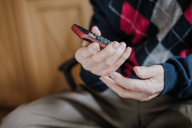 istock Elderly man talking on phone sitting at home 1216761694