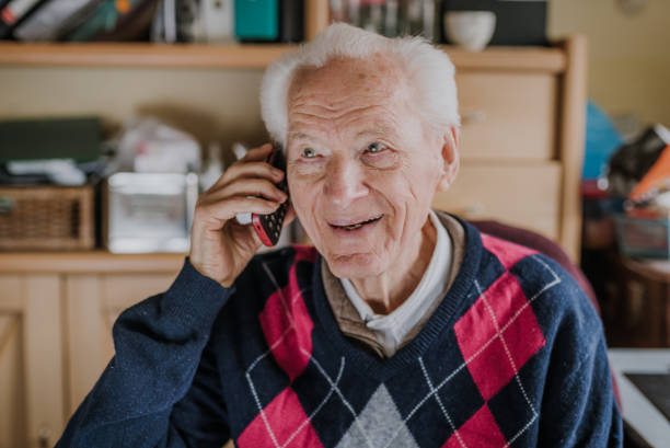 istock Elderly man talking on phone sitting at home 1216761834