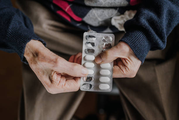 istock Old man holding medicine blister in hands 1216762002