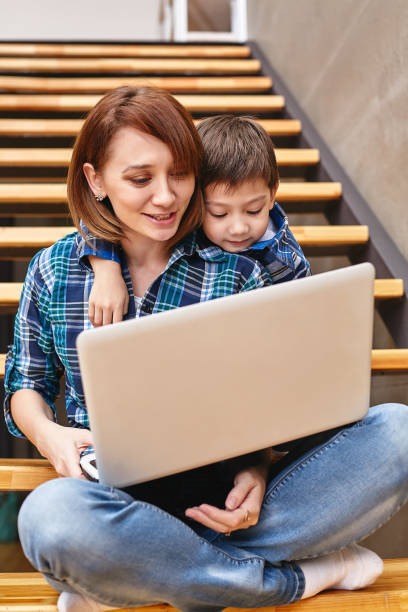 istock Mom and son are doing homework on the computer. Concept mom and children, modern technology and the Internet 1216762127