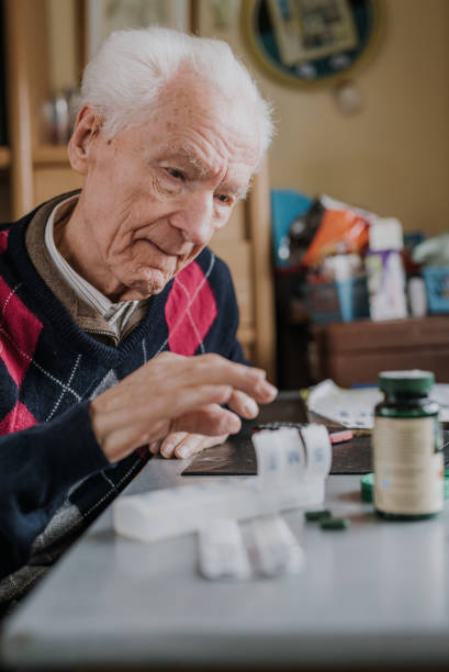 istock Senior arranges medicines for each day of week 1216762334