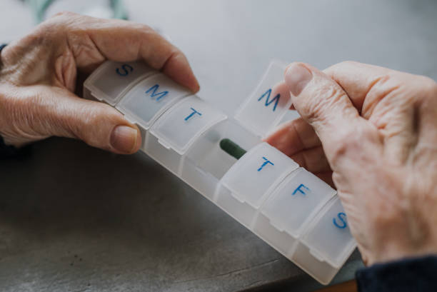 istock Senior arranges medicines for each day of week 1216762391