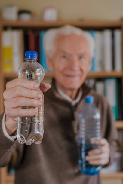 istock Positive senior holding water bottles 1216762509