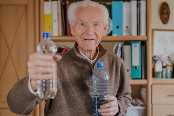 istock Positive senior holding water bottles 1216762537