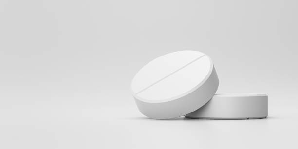 istock White tablets or painkillers with a pharmacy on a medical background. White pills for alleviating illness or fever. 3D rendering. 1216762691