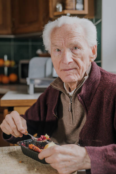 istock Portrait senior eats dinner at home 1216763675