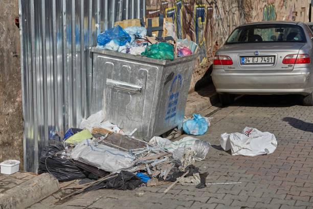 household waste is scattered around the dumpster. - tailings container environment pollution imagens e fotografias de stock