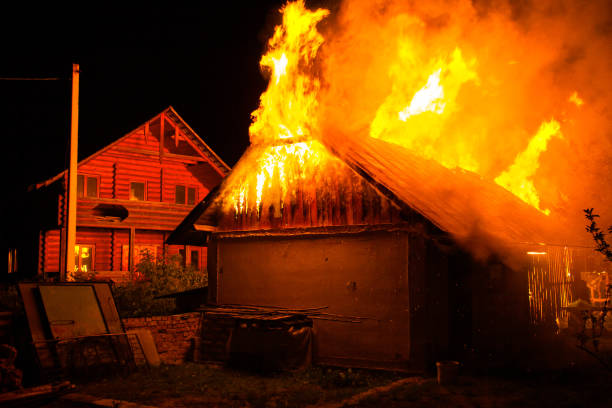 istock Wooden house or barn burning on fire at night. 1216766384