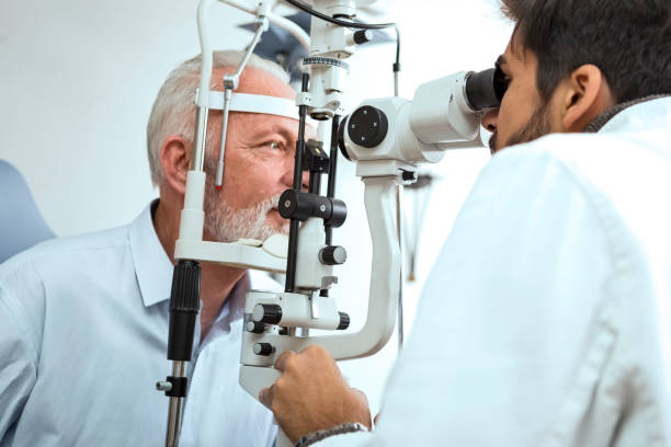 istock Optometrist examining senior mans eyes in his office 1216771853