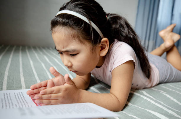 istock child reads a book at home 1216772983