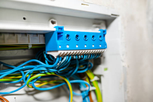 istock Blue self-locking block for neutral electric wires, mounted in the electric box with connected cables. 1216773211
