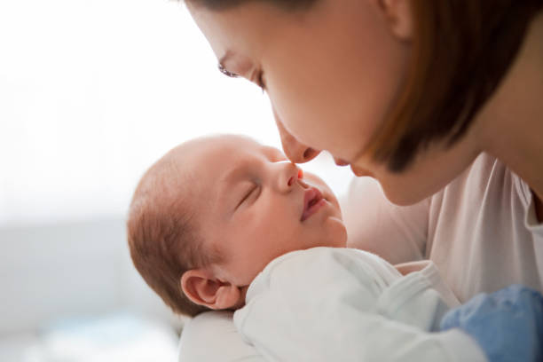 istock Beautiful mother with her baby touching noses 1216773355