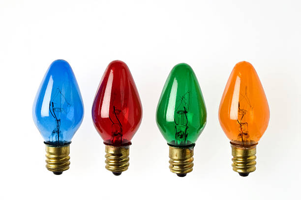Four primary colored Christmas light bulbs in a row