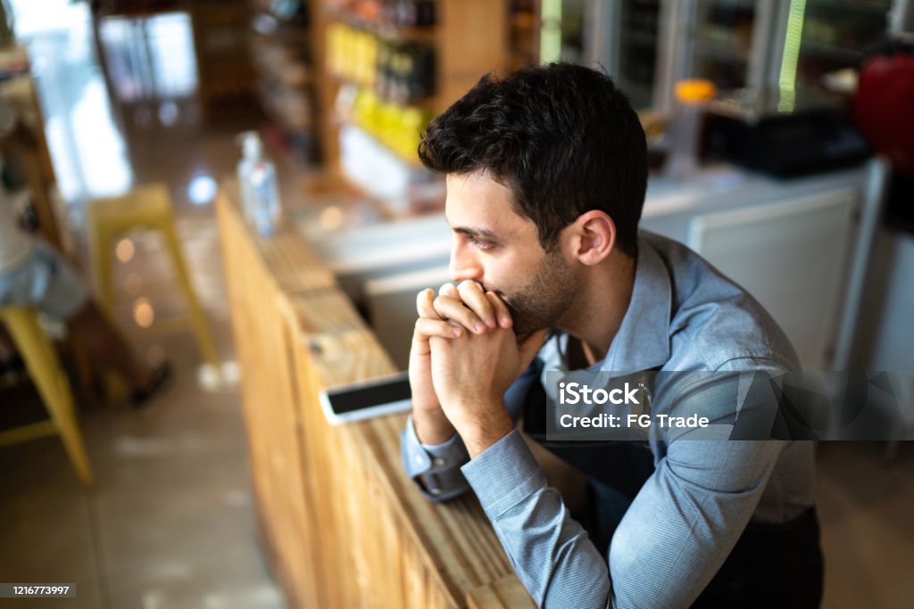 Worried owner at his small business Contemplation Stock Photo