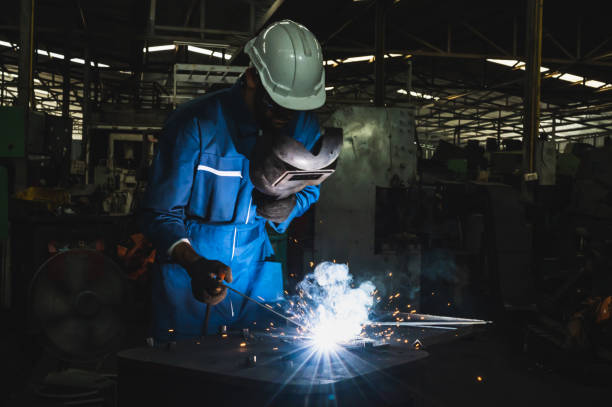 istock Industrial worker welding metal with many sharp sparks 1216774797