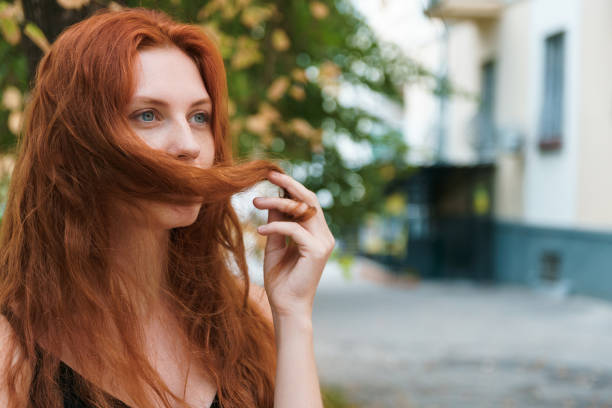 istock Ginger woman with long hairs outdoor 1216776083